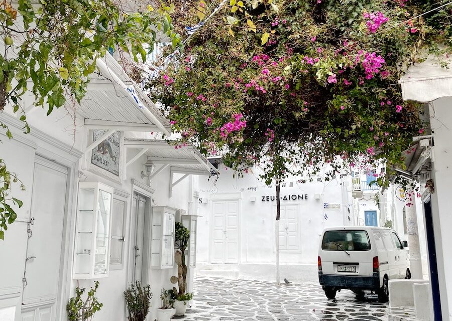 a car is parked on a cobblestone street