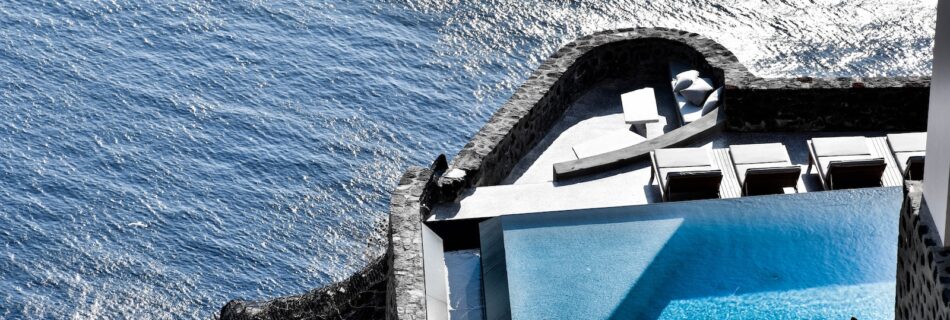 gray and white concrete building over body of water