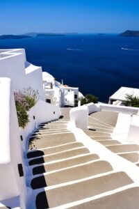 a white staircase leading down to a body of water