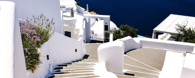 a white staircase leading down to a body of water