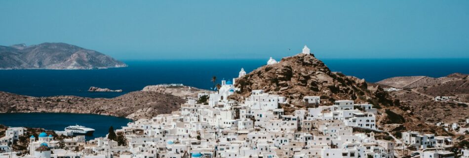 white and brown houses near body of water during daytime