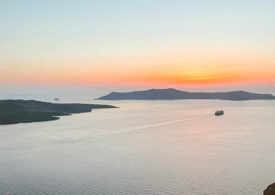 white boat on sea during sunset